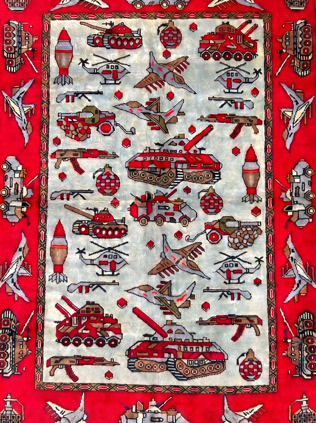 Handwoven Soviet–Afghan war rug depicting military vehicles and weapons
