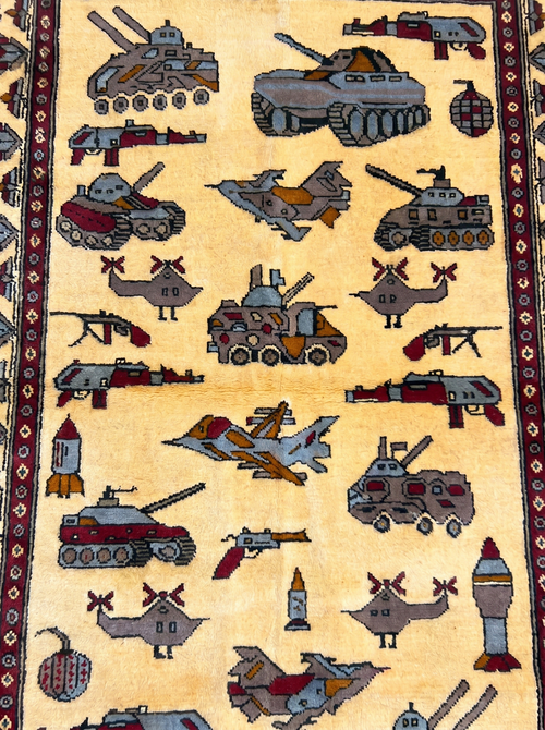 Soviet–Afghan war rug close-up showing handwoven military vehicle motifs